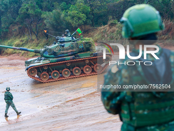 Taiwanese Soldiers stand guard as CM-11 tanks are deployed to a live ammunition military drill at an unnamed  location, amid rising tensions...