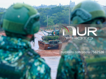 Taiwanese Soldiers stand guard as CM-11 tanks are deployed to a live ammunition military drill at an unnamed  location, amid rising tensions...