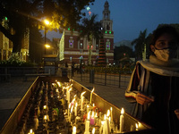 A woman lights up candles outside the Sacred Heart Cathedral ahead of Christmas celebrations, in New Delhi, India on December 23, 2021. (