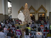 Thai and foreign Catholic church goers attend Christmas Eve at a church in Bangkok, Thailand, 24 December 2021. (