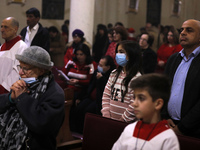 Palestinian Christian worshipers pray on Christmas Eve at at Gaza's Der Latin church on December 24, 2021.
 (