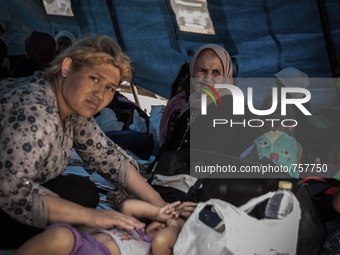 A woman inside a tent for refugee in Gevgelija, on August 26, 2015. The EU is grappling with an unprecedented influx of people fleeing war,...