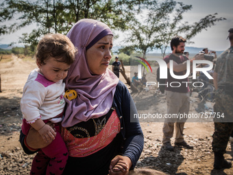 Syrian refugee wait to cross the border between Macedonia and Greece near the Macedonian town of Gevgelija, on August 26, 2015.
The EU is gr...