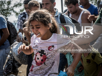 A syrian girl cross the border between Macedonia and Greece near the Macedonian town of Gevgelija, on August 26, 2015.
The EU is grappling w...