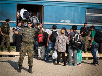 Migrants take the train for for Serbia at the new transit center for migrants at the border line between Greece and Macedonia near the town...