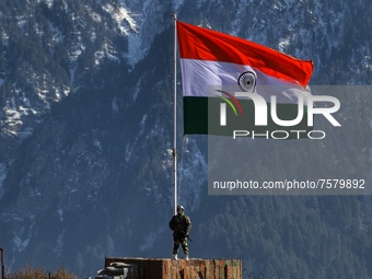 A Border Security Force (BSF) soldier stands alert near Indian National Flag (Tri-Color) at a forward post in Baramulla, Jammu and Kashmir,...