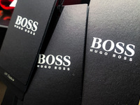 Hugo Boss logos are seen on clothing labels at the store in Krakow, Poland on December 30, 2021. (