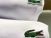 Lacoste logos are seen on clothes at the store in Krakow, Poland on December 30, 2021. (