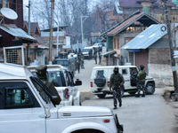 Indian paramilitary troopers stand near the encounter site on the outskirts of Srinagar, Indian Administered Kashmir on 03 January 2022.  To...