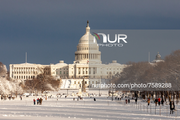 The sun shines on the US Capitol after an unexpected snowstorm dumped roughly 8 inches on Washington, DC. 