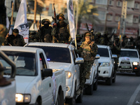 Palestinian members of the Al-Quds Brigades, the military wing of the Islamic Jihad group, march with their rifles along the main road of Ga...
