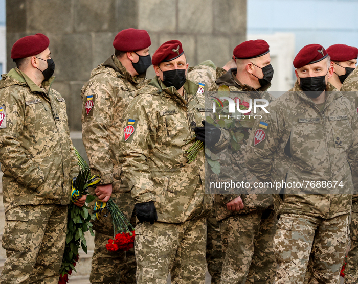 Servicemen of Ukrainian Army hold the flowers as they participate the commemoration rally for those their colleagues who was killed in actio...