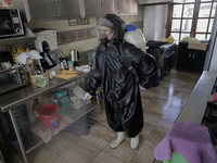 A worker sanitises a kitchen inside the Cathedral of San Bernardino de Siena in Xochimilco, Mexico City, following the increase in COVID-19...