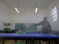 A worker sanitises several classrooms of the Cristóbal Colón Primary School in Xochimilco, Mexico City, following the increase in COVID-19 i...