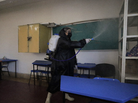 A worker sanitises several classrooms of the Cristóbal Colón Primary School in Xochimilco, Mexico City, following the increase in COVID-19 i...