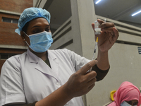 A health worker prepares to inoculate with a first dose of the Moderna COVID19 vaccine during the spread of COVID-19 coronavirus pandemic at...