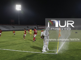 Workers sprays disinfectant to a corner pole during half time of FIFA friendly match between Indonesia against Timor Leste amid Covid-19 pan...