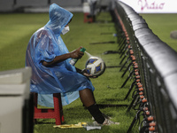 A ball boy sprays disinfectant to a ball during FIFA friendly match between Indonesia against Timor Leste amid Covid-19 pandemic at I Wayan...