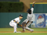 Seattle Mariners' Austin Jackson beats the tag of Detroit Tigers Jose Iglesias, left, to steal second base in the sixth inning of a baseball...