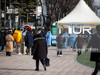 People wait in line at a COVID-19 testing facility at outside of the Seoul City Hall on February 9, 2022 in Seoul, South Korea. South Koreas...