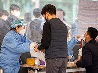 Citizens take a COVID-19 test at testing facility at Seoul Metropolitan Government Hall on February 9, 2022 in Seoul, South Korea. According...