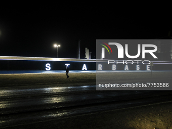 A man walks past the Starbase sign at SpaceX's South Texas campus late Thursday evening after Elon Musk's presentation. (