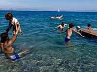 Migrants enjoy a swim on the Greek island island of Kos. Once used by tourists the area is now a small beachfront for migrants. Many of the...