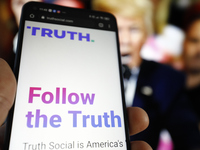 The TRUTH Social website is seen on a mobile device with an image of former US president Donald Trump in the background in this photo illust...