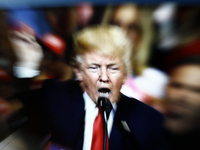 A slow shutter speed image of former US president Donald Trump on a TV screen is seen in this photo illustration in Warsaw, Poland on 23 Feb...
