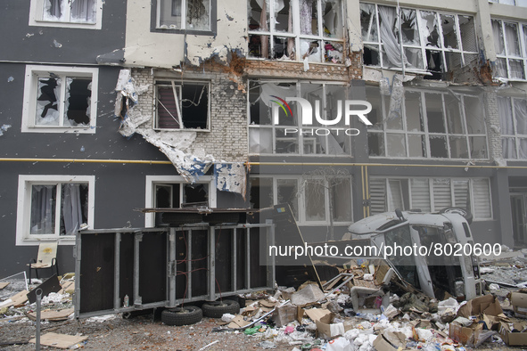 Destroyed civil vehicles  near a damaged residential building in the recaptured by the Ukrainian army Bucha city near Kyiv, Ukraine, 04 Apri...