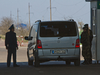 Ukrainian border and customs guards check vehicle at the BCP Customs Control Zone on the border between Ukraine and Moldova (