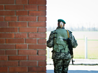 Ukrainian female border guard with a gun patroling at the BCP Customs Control Zone on the border between Ukraine and Moldova (