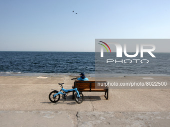 A man rests on the Black Sea embankment of the city of Odesa, Ukraine on 5 April 2022. (