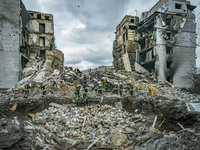 A rescue team clears debris of a destroyed building in Borodianka after the combats between the russian and ukrainian armies during the Russ...