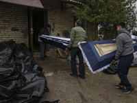 (EDITORS NOTE: Image contains graphic content) Workers of funeral services carry the bodies of the dead of killed people, who were brought t...