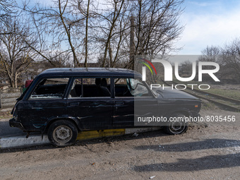 BUCHA, UKRAINE - APRIL 7, 2022 - A damaged car is seen on a street after the liberation of the city from Russian invaders, Bucha, Kyiv Regio...