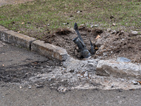 BUCHA, UKRAINE - APRIL 7, 2022 - A shell is stuck in the ground near a curb after the liberation of the city from Russian invaders, Bucha, K...