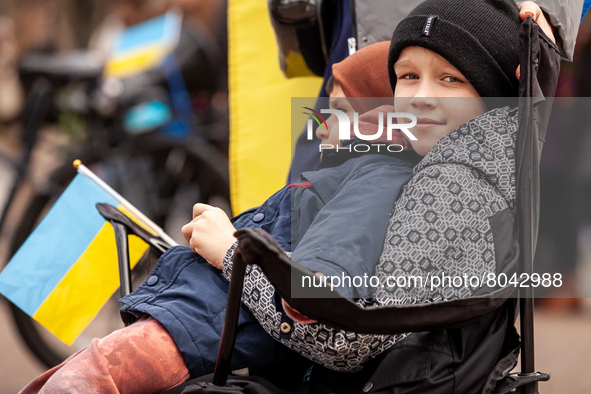 Two children attend a rally at the White House for Ukraine.  Hundreds of people gathered to demand that the United States and the West stop...