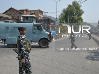 Indian paramilitary troopers stand near the encounter site in in Srinagar, Indian Administered Kashmir on 10 April 2022. Two foreign militan...
