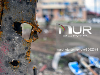 CHERNIHIV, UKRAINE - APRIL 11, 2022 - Shrapnel holes dot a fence after the liberation of the city from Russian invaders, Chernihiv, northern...