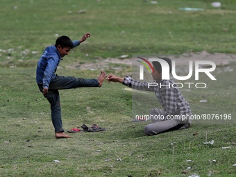 Kashmiri boys fight playfully in a ground in Sopore, Baramulla, Jammu and Kashmir, India on 15 April 2022. (