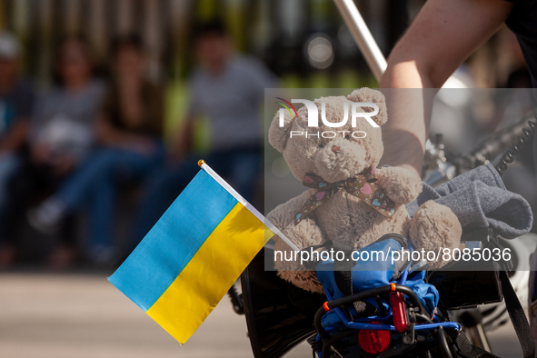 A teddy bear with a Ukrainian flag sits on the back of Gleb Latnik's bicycle during a protest against the war in Ukraine.  Latnik, who has b...
