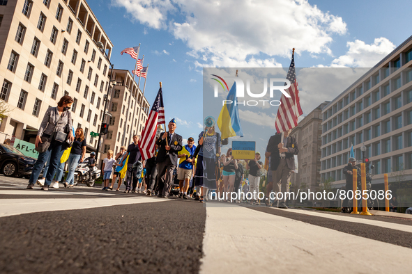 Demonstrators march from the White House to the residence of the Russian ambassador during a protest against the war in Ukraine.  In additio...