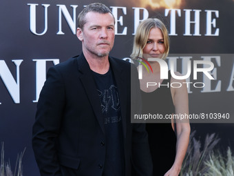 British-Australian actor Sam Worthington and wife/Australian model Lara Worthington arrive at the Los Angeles Premiere Of FX's 'Under The Ba...
