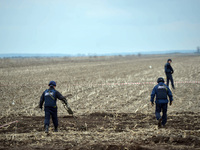 KYIV REGION, UKRAINE - APRIL 21, 2022 - EOD experts of the State Emergency Service search for explosives in the field during a mine clearanc...