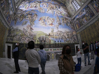 Visitors attend the exhibition of Michelangelo's work inside the replica of the Sistine Chapel installed in the zocalo of Mexico City. For t...