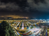 Hong Kong, China, 24 Apr 2022, A drone panorama of the Penny Bay's Community Isolation Facility at night. On the far right, works on the ext...