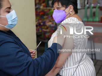 A person receives a Covid-19 booster dose during a vaccination program in the local markets as attempt to reduce risk of contagion. On April...