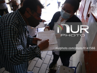 A Person fill out a form preview to receive a  Covid-19 booster dose during a vaccination program in the local markets as attempt to reduce...