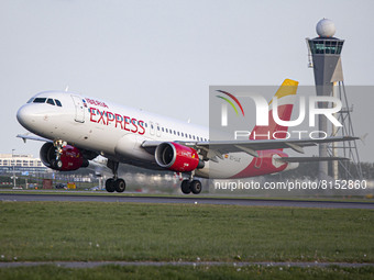Iberia Express Airbus A320 aircraft as seen departing from Amsterdam Schiphol AMS EHAM airport. The passenger jet plane is passing in front...